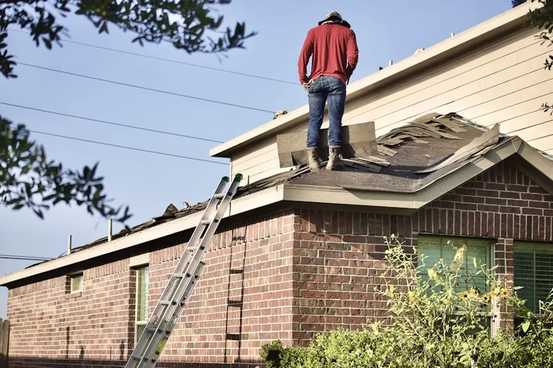 Professional roofer working on a residential roof in Cloverly